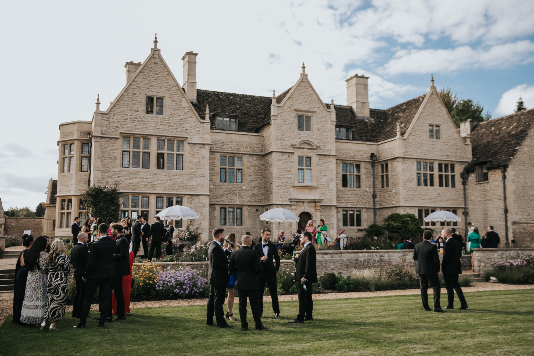 A colour image of the front of wedding venue Kin House in Wiltshire in the sunshine in peak wedding season. 