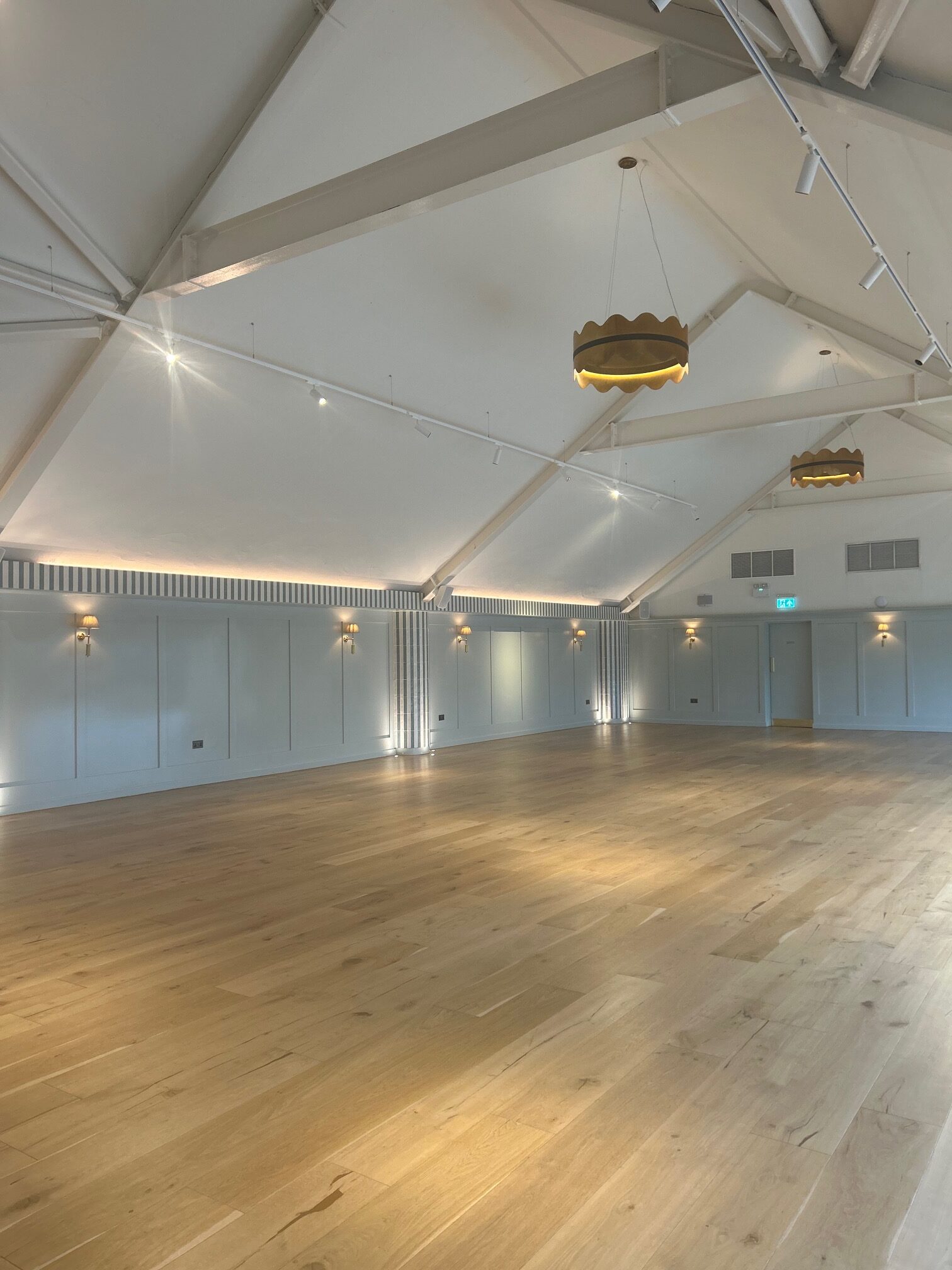 A colour image of the front of wedding venue Kin House in Wiltshire in the sunshine in peak wedding season. 