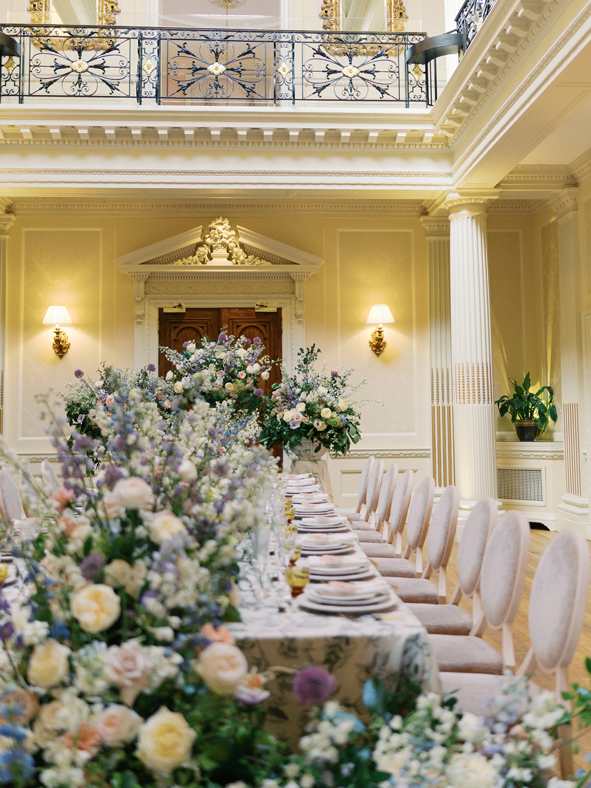 A colour image of the main hall at Hedsor House with a long table ready for a spring wedding. 