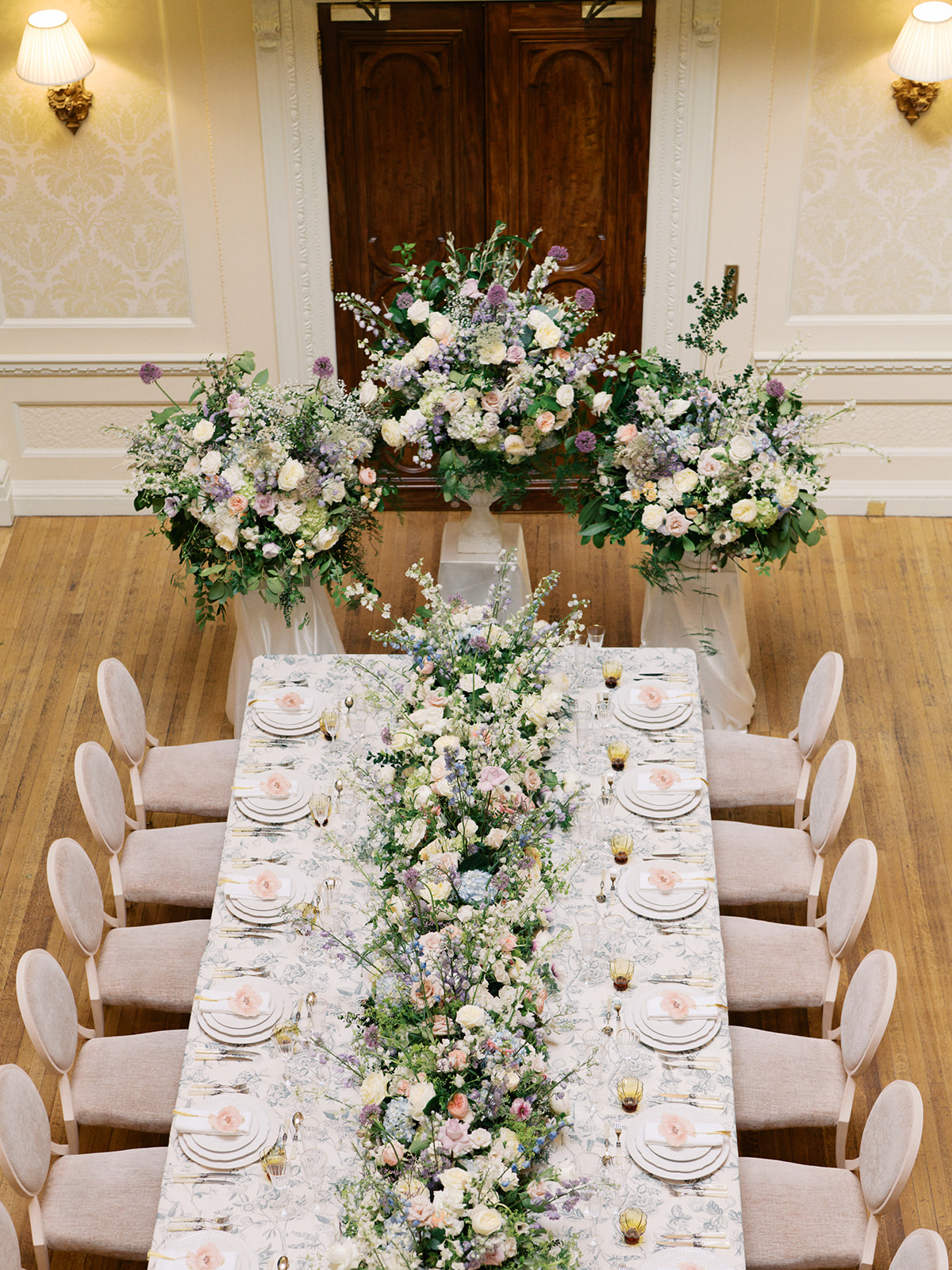A colour image of the main hall at Hedsor House with a long table ready for a spring wedding. 