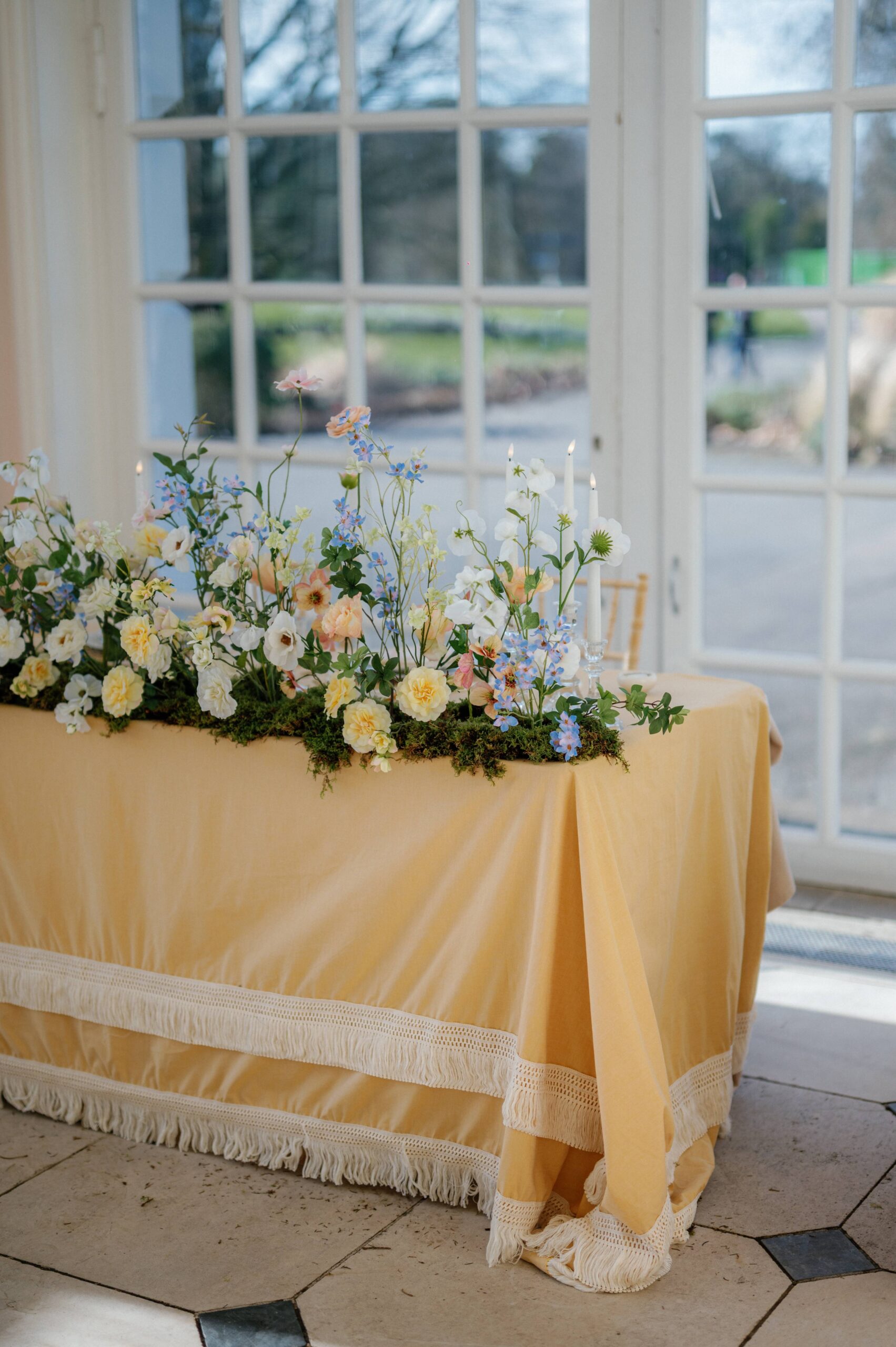 A spring wedding dining table at UK wedding venues Kew Gardens, table designed by wedding planner Soirée Studio.