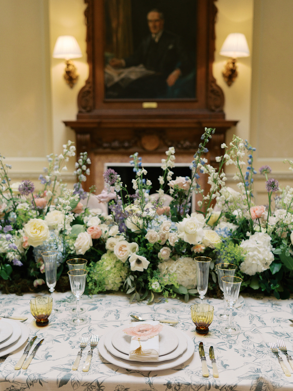 A colour image of a place setting for a wedding with spring flowers by Soirée Studio at Hedsor House.
